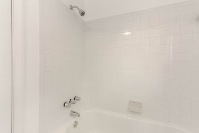 interior details featuring tiled shower / bath