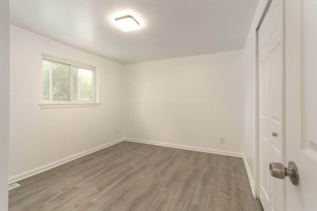 unfurnished room featuring dark hardwood / wood-style flooring