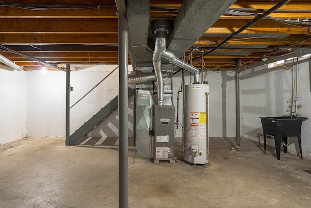 basement with heating unit, sink, and water heater