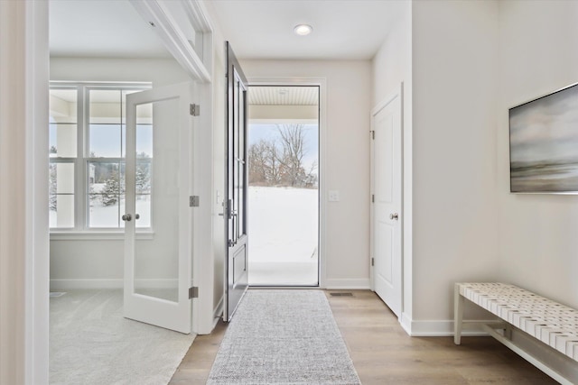 entrance foyer featuring light wood-style flooring and baseboards