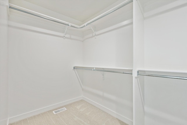 spacious closet with carpet floors and visible vents