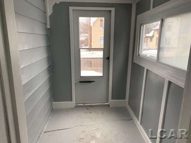 551 Tabor St, Adrian, MI 49221 - doorway to outside featuring baseboards