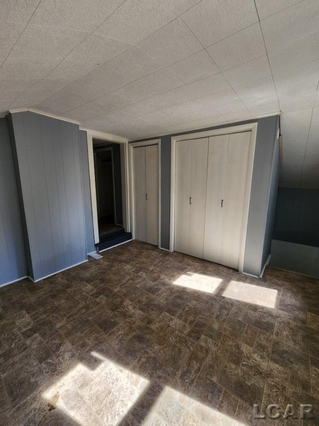 unfurnished bedroom with two closets