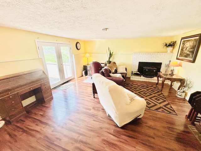 living room with wood-type flooring, a textured ceiling, and french doors