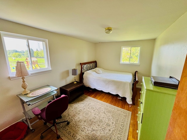 bedroom featuring hardwood / wood-style floors and multiple windows