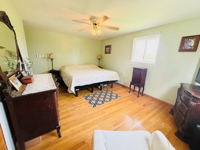 bedroom with ceiling fan and light hardwood / wood-style flooring