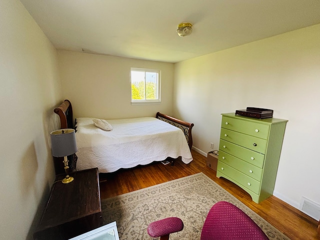 bedroom featuring dark hardwood / wood-style flooring