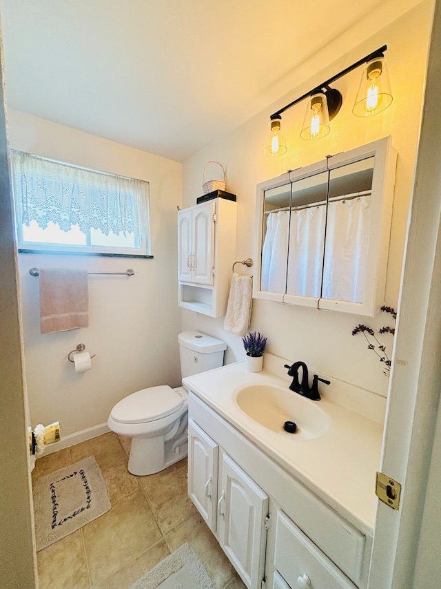 bathroom featuring tile patterned floors, vanity, and toilet