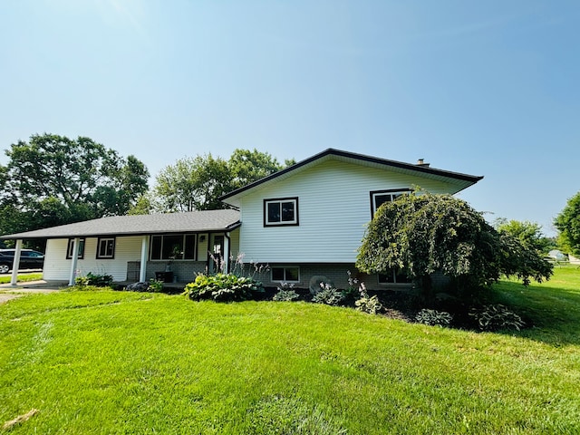 view of front facade with a carport and a front yard