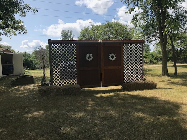 view of outbuilding with a yard