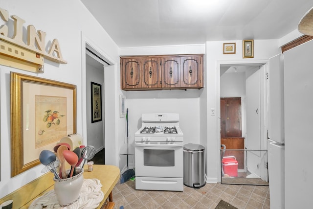 kitchen featuring white range with gas stovetop