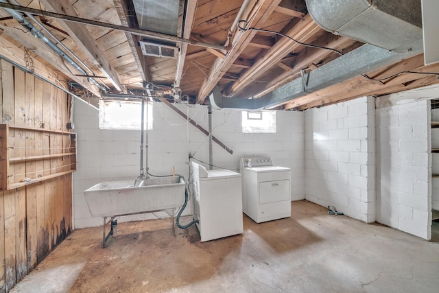 basement with independent washer and dryer and sink