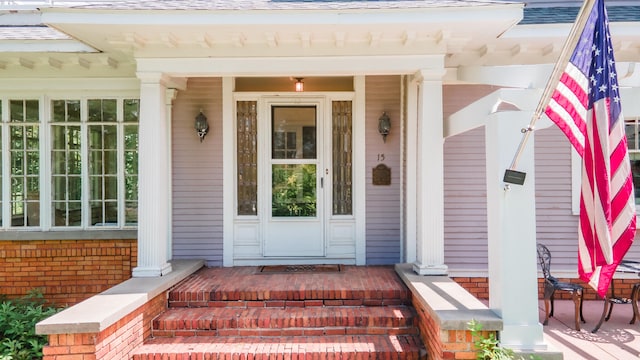 view of exterior entry featuring a porch