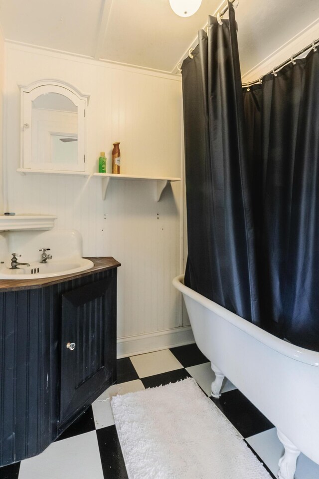 15 S Broad St, Hillsdale, MI 49242 - full bathroom with tile patterned floors, a freestanding bath, vanity, and curtained shower