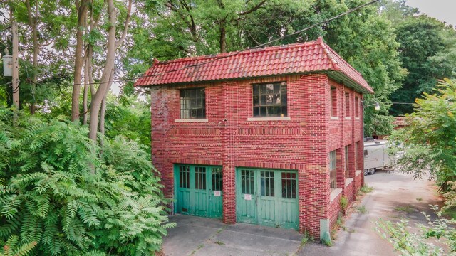 15 S Broad St, Hillsdale, MI 49242 - view of property exterior with brick siding and a tile roof