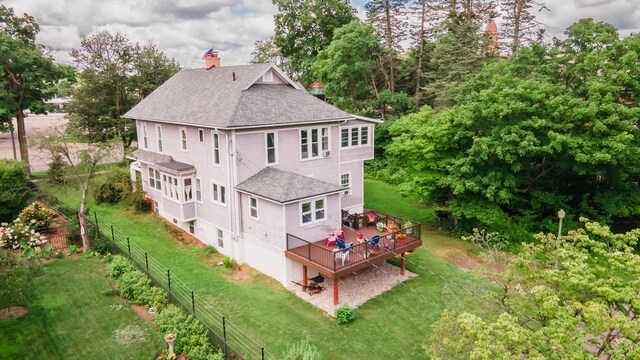 15 S Broad St, Hillsdale, MI 49242 - rear view of property with a shingled roof, a deck, a chimney, and view of wooded area