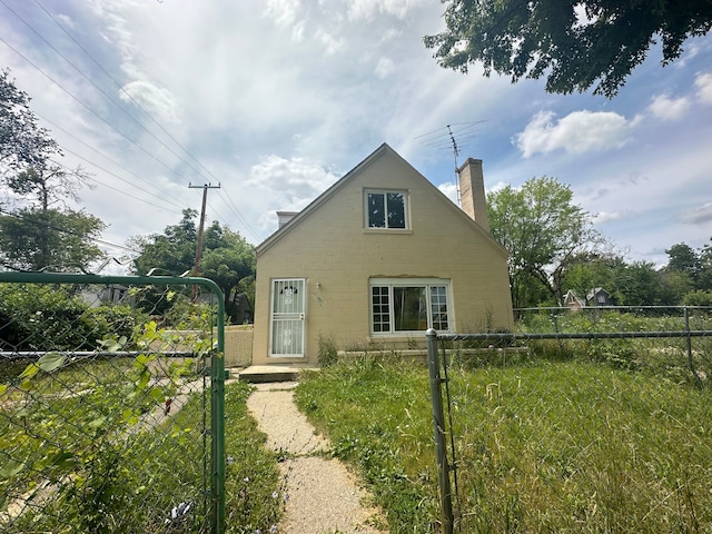 19531 Anvil St, Detroit, MI 48205 - view of front of property featuring a gate, a chimney, and concrete block siding