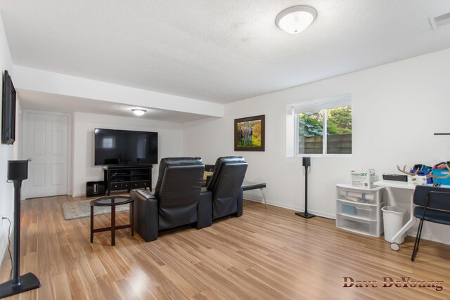 living room featuring a textured ceiling and hardwood / wood-style flooring