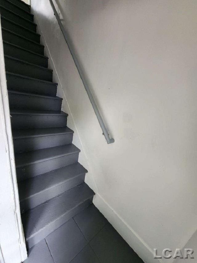 stairs featuring tile patterned floors