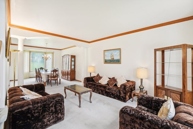 living area with an inviting chandelier, crown molding, carpet, and decorative columns