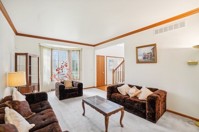 living area featuring visible vents, carpet flooring, baseboards, and crown molding
