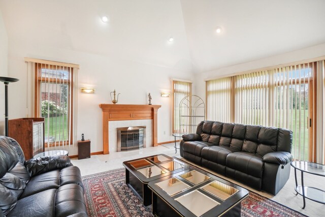 living area with recessed lighting, baseboards, lofted ceiling, and a fireplace