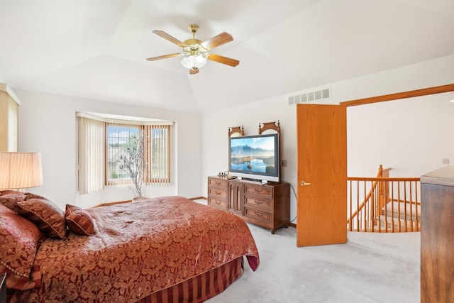 bedroom featuring light colored carpet, ceiling fan, vaulted ceiling, and visible vents