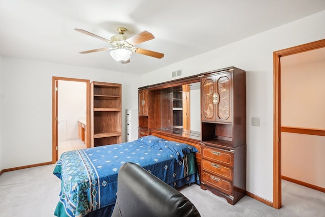 bedroom with baseboards, light colored carpet, and visible vents
