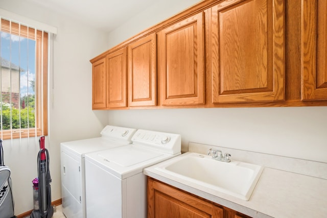 laundry area featuring a sink, cabinet space, and washer and dryer