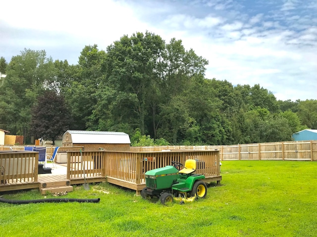 view of yard with a storage unit and a wooden deck