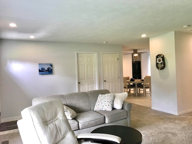 living room with light carpet and ceiling fan