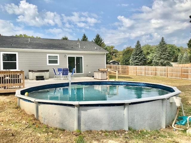 view of swimming pool featuring a hot tub