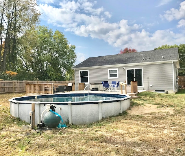 view of pool with a deck and a lawn