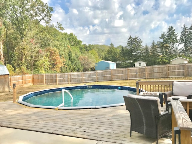 view of swimming pool with a deck