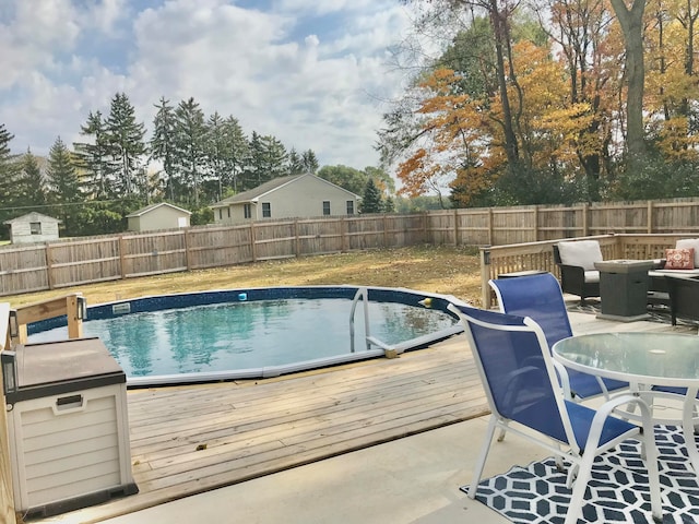 view of swimming pool featuring a wooden deck