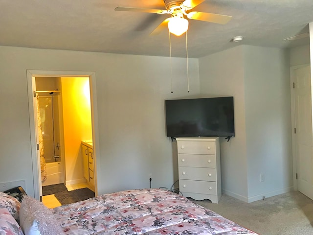 bedroom with carpet flooring, connected bathroom, and ceiling fan