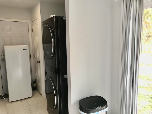 laundry area with stacked washing maching and dryer