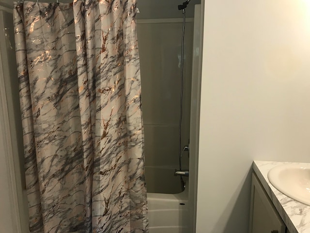 bathroom with shower / bath combo and vanity