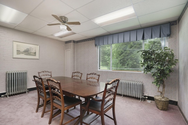 801 Portage Ave, Three Rivers, MI 49093 - carpeted dining room with radiator, a paneled ceiling, and ceiling fan