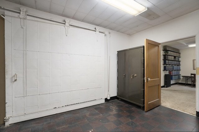 801 Portage Ave, Three Rivers, MI 49093 - basement featuring dark flooring and a baseboard heating unit