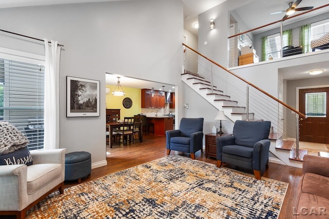 living room featuring dark hardwood / wood-style flooring, high vaulted ceiling, and a healthy amount of sunlight