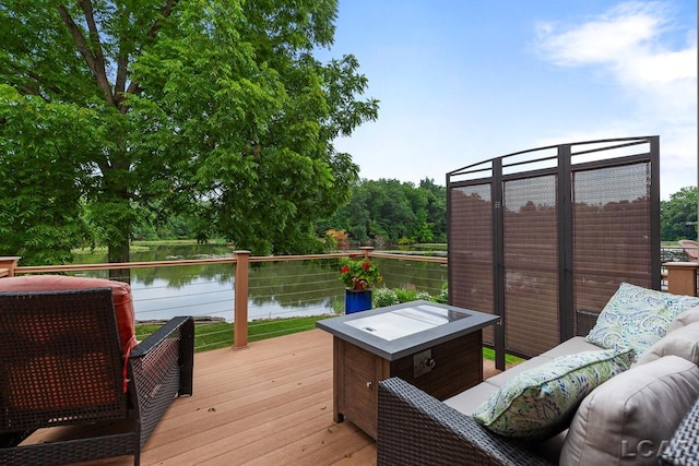 wooden terrace featuring an outdoor hangout area and a water view