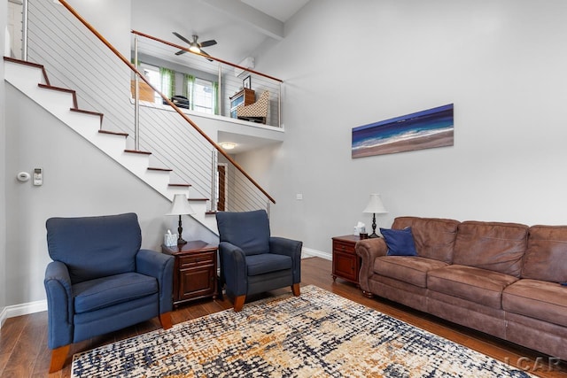 living room featuring ceiling fan, dark hardwood / wood-style flooring, high vaulted ceiling, and beamed ceiling