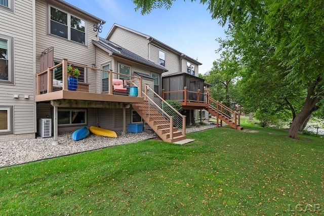 rear view of property featuring a sunroom, a yard, cooling unit, and a deck