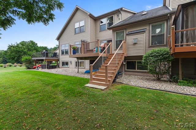 back of property featuring a deck and a lawn