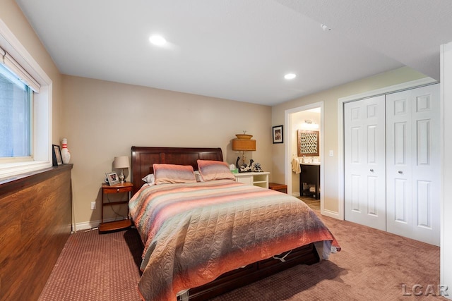 bedroom with carpet, ensuite bath, and a closet