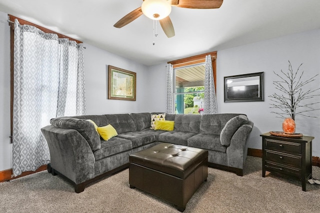 carpeted living room with ceiling fan