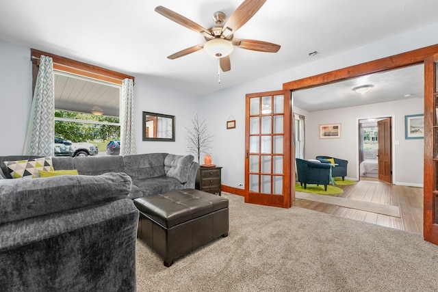 living room featuring ceiling fan and light hardwood / wood-style flooring