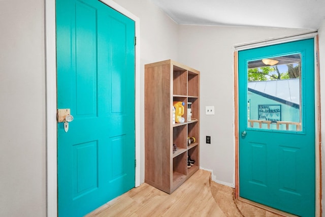 entrance foyer featuring vaulted ceiling and light hardwood / wood-style flooring