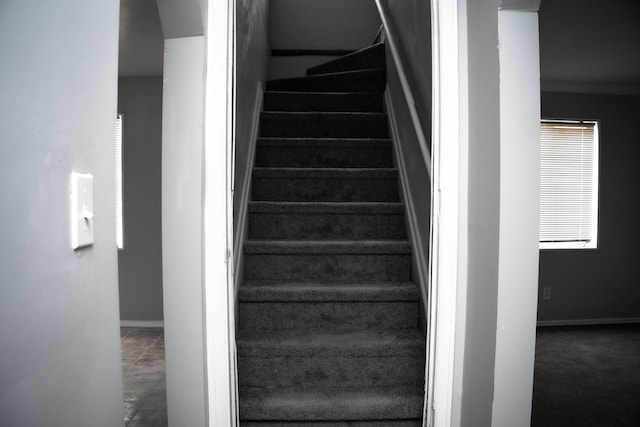 stairs with tile patterned flooring and ornamental molding